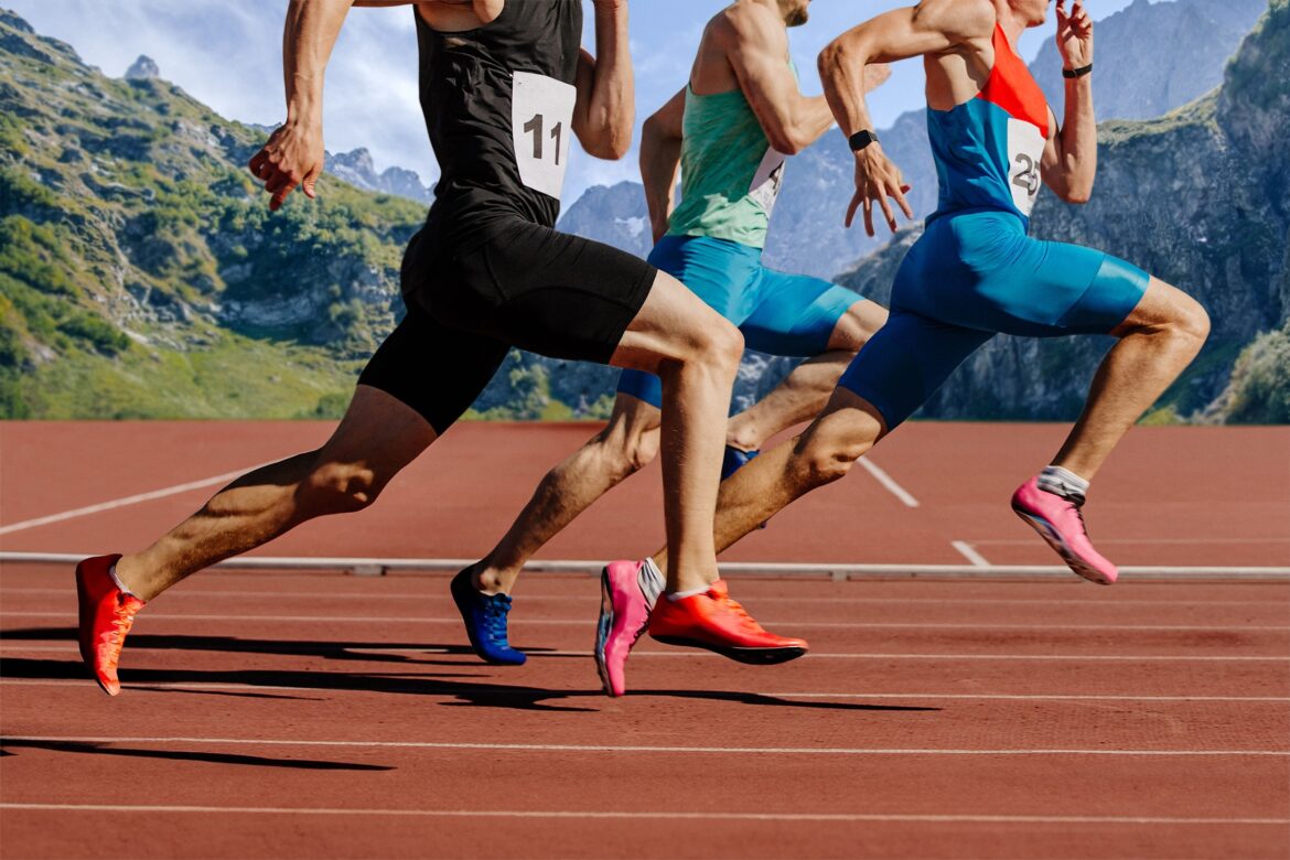 group male athletes running on red track stadium on background mountains and sky. muscles taut, competing fiercely representing the concept of high endurance sports