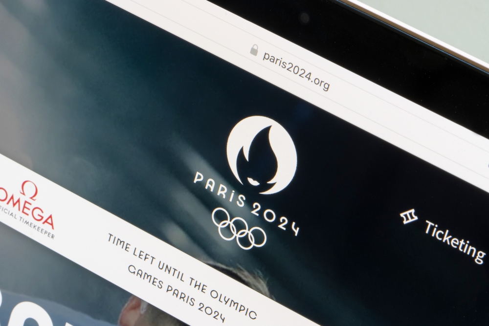 The official website of the Paris 2024 Organizing Committee for the Olympic and Paralympic Games is seen on a smartphone.