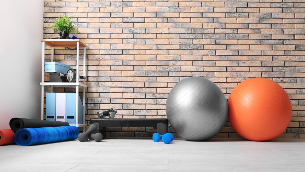 A corner in the gym where swiss balls, yoga mats and dumbbells are placed